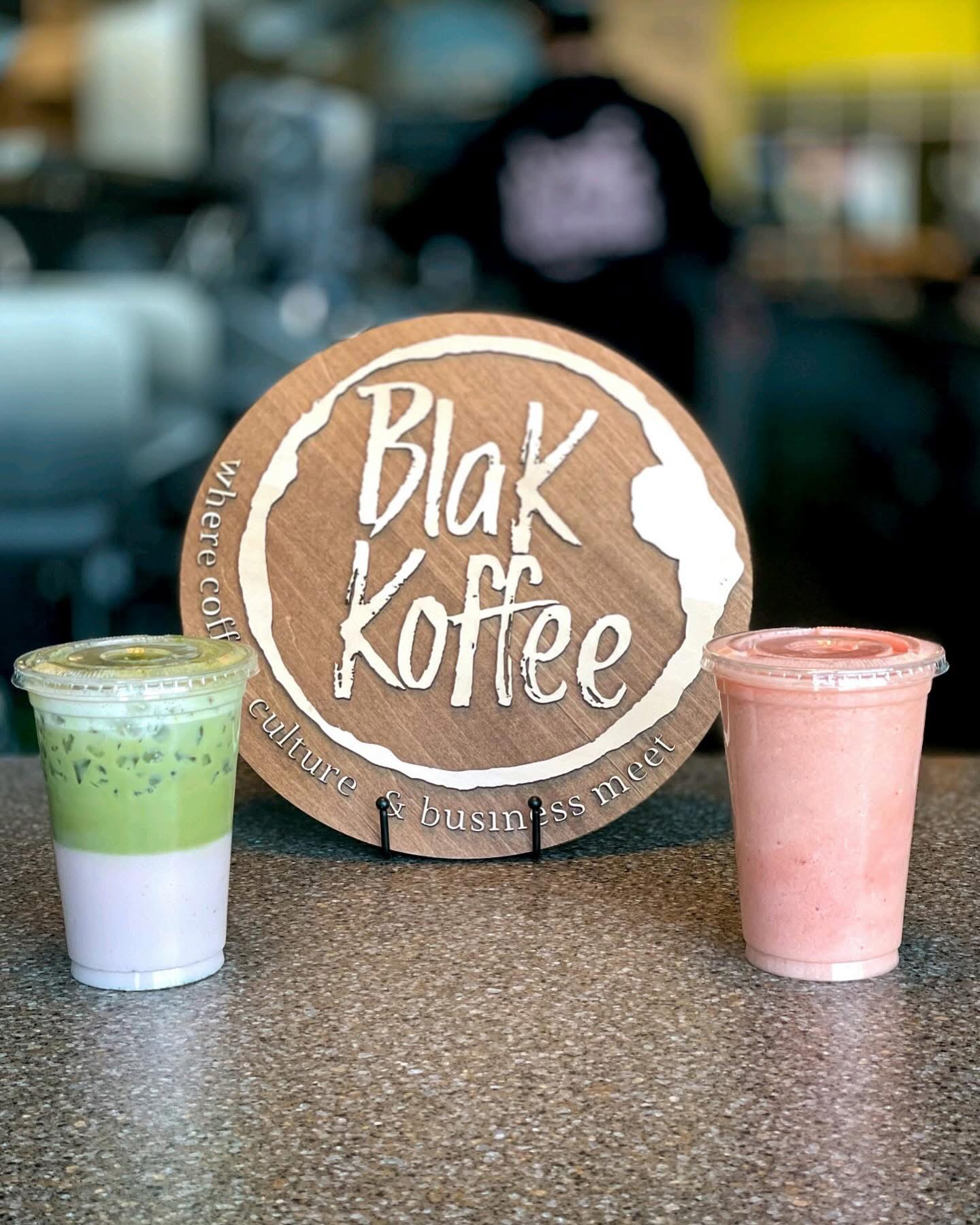 Matcha latte and strawberry smoothie beside the Blak Koffee logo sign